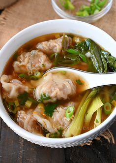 a white bowl filled with meat and vegetable soup