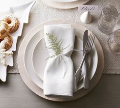 a place setting with silverware and napkins