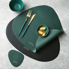 the placemat is designed to look like it has fruit on it and two forks