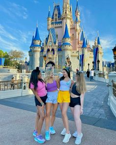 three girls standing in front of a castle