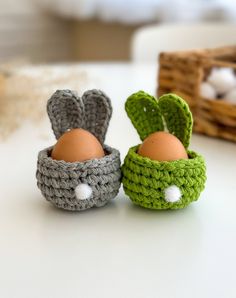 two small crocheted baskets with eggs in them