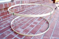 a glass table sitting on top of a brick floor