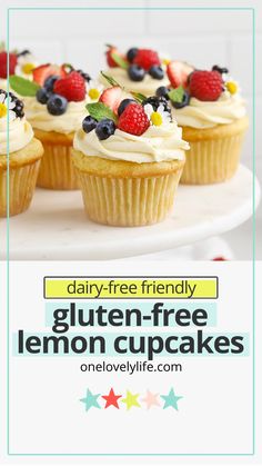 cupcakes with white frosting and berries on top are arranged on a plate