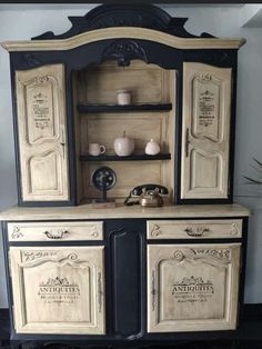 an old fashioned china cabinet painted black and white