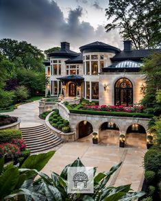 a large white house surrounded by trees and flowers