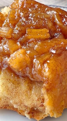 a piece of bread with caramel sauce on it is sitting on a white plate