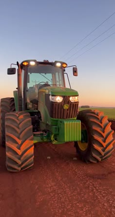 a tractor is parked in the middle of a dirt field