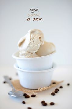 two scoops of ice cream in a white bowl with coffee beans on the side