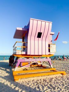 a lifeguard stand on the beach with people in the background