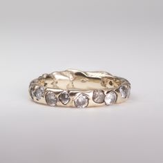 a gold ring with white diamonds on it