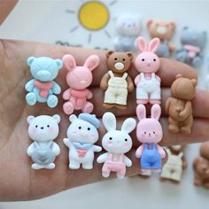 a hand holding a bunch of small toy animals