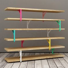 a wooden shelf with different colored shelves on it