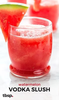 watermelon vodka slush in a glass garnished with a slice of lime