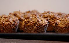 some muffins are sitting on a black tray