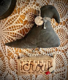 an odd looking object is sitting on a doily next to a small purse with the word oupa written in cursive writing