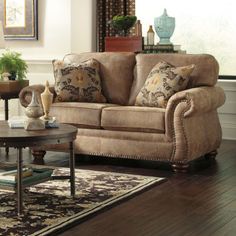 a living room scene with focus on the couch and coffee table in the foreground