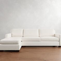 a white couch sitting on top of a wooden floor