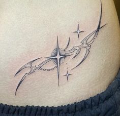 a woman's stomach with an abstract tattoo design on the side, and stars in the background