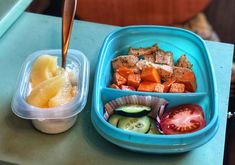 there is a container with some food in it next to another container on the table