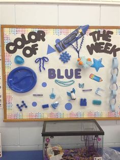 a bulletin board with blue items on it and the words color of the week written in black