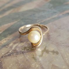 This is a vintage, 14 Karat gold and pearl ring. It has stamped 14 K and has tested positive for 14 karat gold.All sales are final.  This ring is a size 6 and can be sized. Please note, sizing is up to the buyer. I do not provide this service. If you have a wish list or are looking for something specific, please ask. I may have exactly what you are looking for.  As always please convo me with any questions or concerns regarding this item or with any international shipping questions. Unfortunately I do not accept returns or grant refunds. All shipping fees include handling fees. If you would like to combine shipping costs for more than one item, I would be happy to do so if you convo me before purchase.  Purchasing my item means you have read, understood and will abide by my policies. Sorry Chic Engagement Rings, Emerald And Pearl Engagement Ring, Pearl Rings In Gold, Angel Rings, Pearl Engagement Rings, Pearl Ring Design, Ring With Pearls, Pearl Gold Ring, Pearls Ring