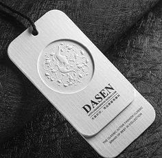 a close up of a tag on a black leather surface with the word dashen printed on it