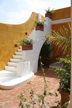 an outdoor area with stairs and potted plants