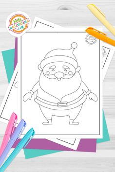 a christmas coloring page with markers, pens and pencils on the table next to it