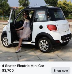 a woman sitting in the driver's seat of a mini car