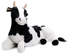 a black and white stuffed cow laying down