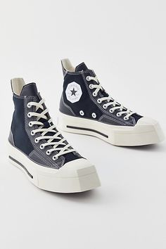 Converse Chuck 70 De Luxe high tops get a bold angular update for a squared-toe platform silhouette. Features Converse Chuck 70 De Luxe Squared high top sneakers Angular square-toe sneakers Canvas with faux leather details Flatform platform sole with an angular toe OrthoLite insoles for a comfy step High top lace-up sneaker style Content + Care Cotton, PU, rubber Spot clean Imported | Converse Chuck 70 De Luxe Squared High Top Sneaker in Black, Women's at Urban Outfitters Men's Shoes Accessories, Sneaker Style, Converse Chuck 70, High Top Sneaker, Chuck 70, Women Men Shoes, Black Fits, Converse Chuck, Chucks Converse