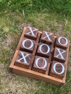 wooden tic - tac - toe game set with xoxo on it