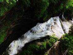 the water is rushing down the side of the mountain