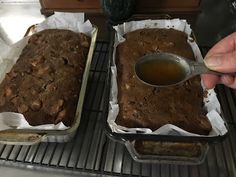 two pans filled with brownies sitting on top of a metal rack next to each other