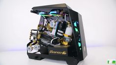 a black and gold computer case with assorted parts on it's sides, in front of a white background