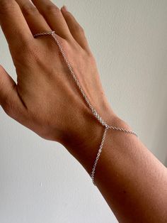 ✨ Perfectly simple silver dainty hand chain featuring a straight crystal pendant. This fits perfectly on your middle finger and attaches as a bracelet.  ✨ Please choose your ring size! ✨ Bracelet measures about 6.5 inches (and will be proportionate to your ring size). ✨ Free shipping in the U.S!  You can see other hand chains here:  https://www.etsy.com/shop/houseofgilt/?section_id=17203243 Follow and tag me on Instagram @houseofgilt @houseofgilt @houseofgilt Minimalist Sterling Silver Chain Bracelet For Party, Dainty Sterling Silver Chain Bracelet For Party, Sterling Silver Adjustable Chain Bracelet For Party, Adjustable Sterling Silver Chain Bracelet For Party, Adjustable Silver Chain Ring For Parties, Silver Hand Chain, Silver Adjustable Body Jewelry For Gift, Adjustable Silver Body Jewelry Gift, Dainty Silver Jewelry With Extender