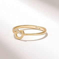 a gold ring with two diamonds on it