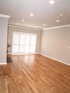 an empty living room with hard wood floors and white walls is featured on instagram