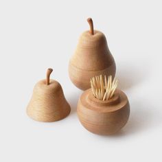 three small wooden pears with toothpicks in them