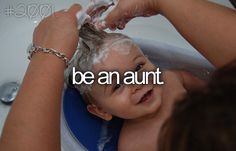 a baby being washed in a bathtub with the words be an aunt above it