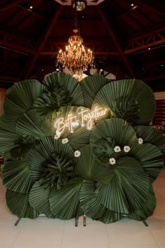 a large green plant with the words buffet together on it's backlit sign