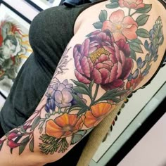 a woman with a flower tattoo on her arm