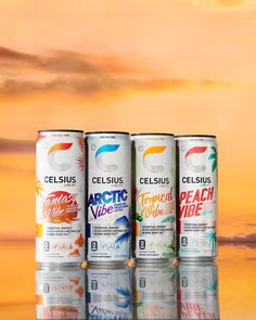 four cans of celsius energy drink in front of a sunset