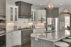 a large kitchen with an island in the middle and lots of stools around it