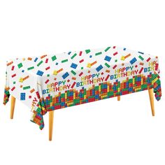 a birthday party table cover with legos on it