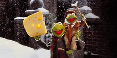 the muppets are holding cheese and posing in the snow