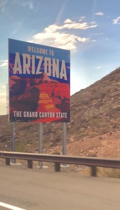 a welcome to arizona sign on the highway