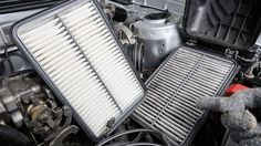 the engine compartment of a car with two air filters on it's hood and an open canister