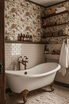 an old fashioned bathtub in a bathroom with floral wallpaper and shelving above it