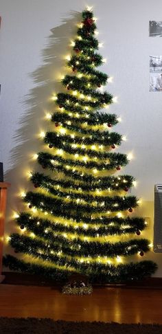 a christmas tree is lit up with lights